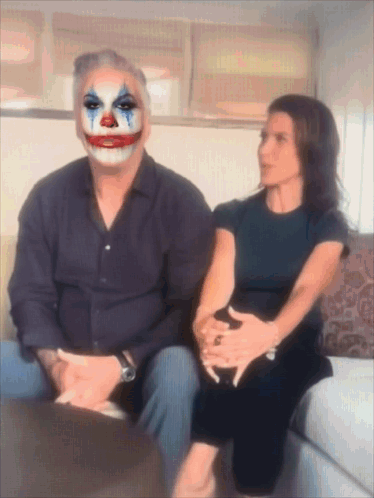 Man In Clown Mask Sitting Next To Woman GIF