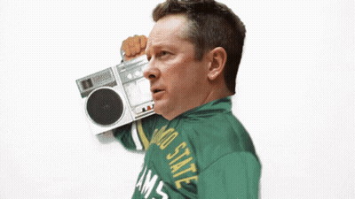A Man Wearing A Colorado State Rams Jacket Holds A Boombox GIF