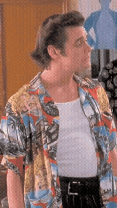A Man Wearing A Colorful Shirt And A White Tank Top . GIF