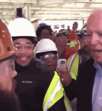 A Man Wearing A Columbia Jacket Stands In A Crowd GIF