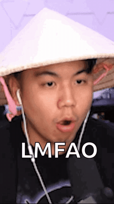 A Man Wearing A Conical Hat And Earbuds Is Making A Funny Face And Says Lmfao . GIF