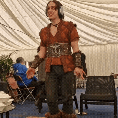 A Man Wearing A Costume With A Belt That Says ' Armour ' On It GIF