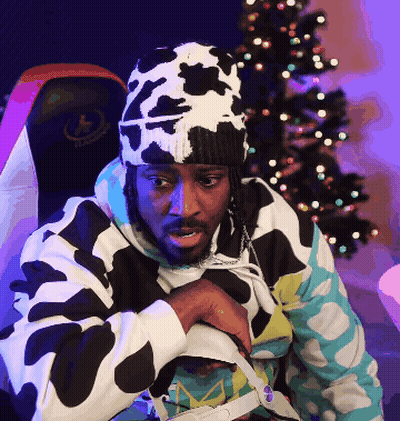 A Man Wearing A Cow Print Hat Is Sitting In Front Of A Halo Chair GIF