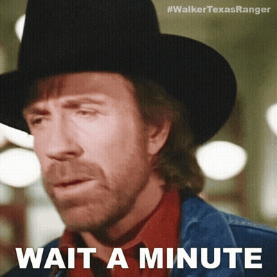 A Man Wearing A Cowboy Hat And A Denim Jacket Says " Wait A Minute " GIF