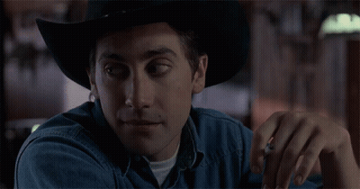 A Man Wearing A Cowboy Hat And A Denim Shirt GIF