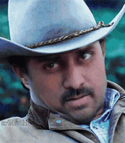 A Man Wearing A Cowboy Hat And A Jacket GIF