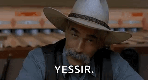 A Man Wearing A Cowboy Hat And A Mustache Is Sitting In Front Of A Bowling Alley . GIF