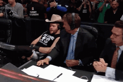 A Man Wearing A Cowboy Hat And A Shirt With The Number 42 On It Sits In A Chair GIF