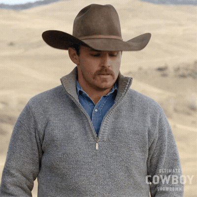 A Man Wearing A Cowboy Hat And A Sweater That Says Ultimate Cowboy Showdown On It GIF