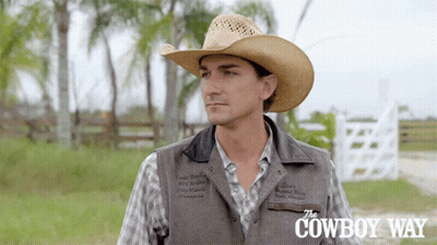 A Man Wearing A Cowboy Hat And A Vest With The Cowboy Way Written On The Bottom GIF
