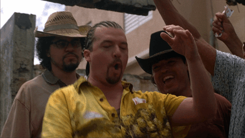 A Man Wearing A Cowboy Hat And A Yellow Shirt With The Letter Y On It GIF