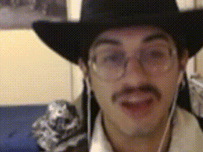 A Man Wearing A Cowboy Hat And Glasses Is Talking GIF