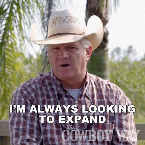 A Man Wearing A Cowboy Hat And Plaid Shirt Says I 'M Always Looking To Expand GIF
