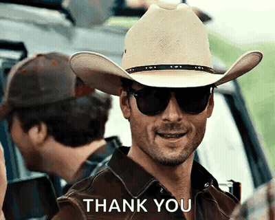 A Man Wearing A Cowboy Hat And Sunglasses Is Smiling And Saying Thank You . GIF