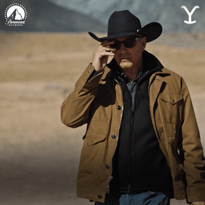 A Man Wearing A Cowboy Hat And Sunglasses Talks On A Cell Phone GIF