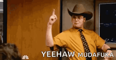 A Man Wearing A Cowboy Hat And Tie Is Pointing His Finger Up . GIF