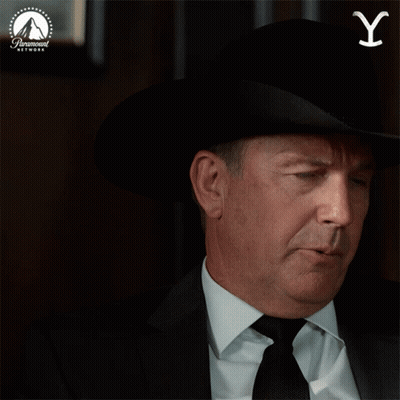 A Man Wearing A Cowboy Hat And Tie Is Pointing Up With A Paramount Network Logo In The Background GIF