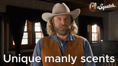 A Man Wearing A Cowboy Hat And Vest With The Words Unique Manly Scents Below Him GIF