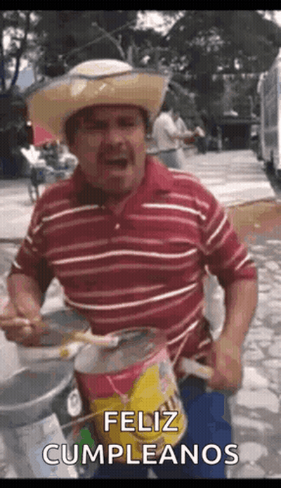 A Man Wearing A Cowboy Hat Is Playing A Drum And Singing . GIF