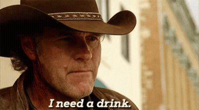 A Man Wearing A Cowboy Hat Is Saying I Need A Drink GIF