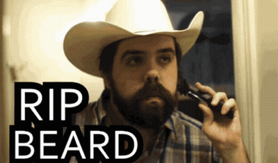 A Man Wearing A Cowboy Hat Is Shaving His Beard GIF