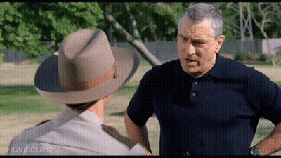 A Man Wearing A Cowboy Hat Is Talking To Another Man GIF