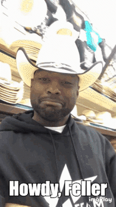 A Man Wearing A Cowboy Hat With The Words Howdy Feller Written On It GIF