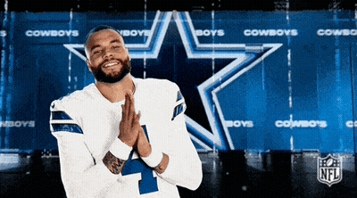 A Man Wearing A Cowboys Jersey Prays In Front Of A Star GIF