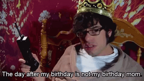 A Man Wearing A Crown And Glasses Is Holding A Cell Phone And Saying The Day After My Birthday Is Not My Birthday Mom GIF