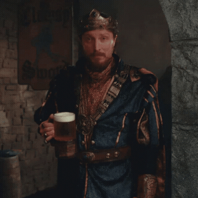 A Man Wearing A Crown Holds A Glass Of Beer GIF