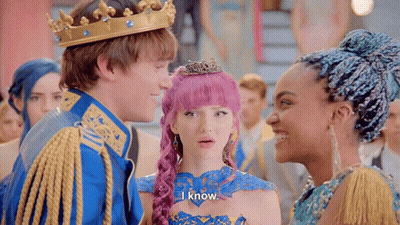 A Man Wearing A Crown Is Standing Next To A Woman With Pink Hair And A Girl With Blue Hair . GIF