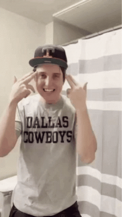 A Man Wearing A Dallas Cowboys Shirt And Hat GIF
