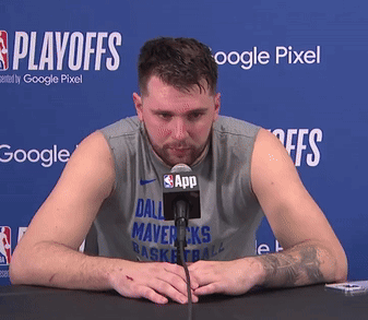 Man In Dallas Mavericks Shirt At Table With Microphone GIF