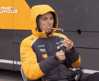 A Man Wearing A Dell Jacket Is Blowing A Party Horn GIF