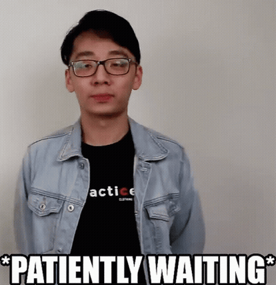 A Man Wearing A Denim Jacket And A Black Shirt With The Words Patiently Waiting GIF