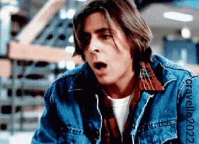 A Man Wearing A Denim Jacket And A Plaid Shirt Has The Year 2022 On The Sleeve Of His Jacket GIF