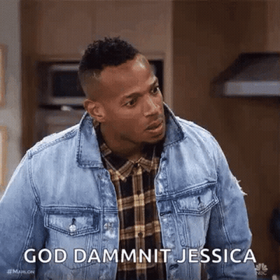 A Man Wearing A Denim Jacket And A Plaid Shirt Is Standing In A Kitchen . GIF