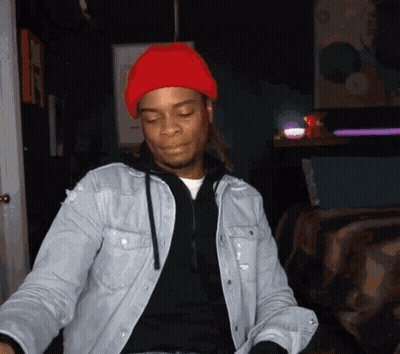 A Man Wearing A Denim Jacket And A Red Beanie GIF