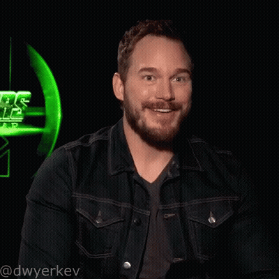 A Man Wearing A Denim Jacket Is Laughing In Front Of A Star Wars Sign GIF