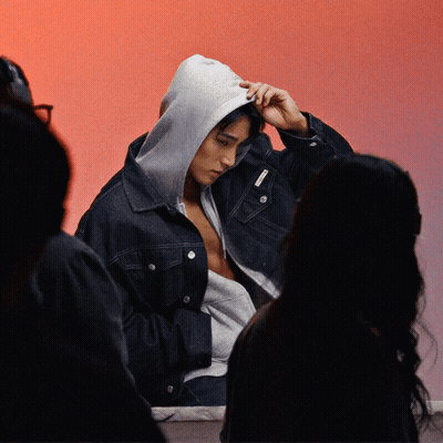 A Man Wearing A Denim Jacket With A Hood On His Head GIF