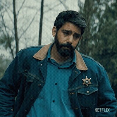 A Man Wearing A Denim Jacket With A Sheriff 'S Badge On His Chest GIF