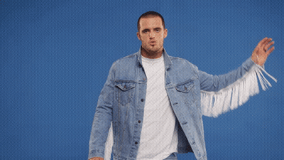 A Man Wearing A Denim Jacket With White Fringe GIF