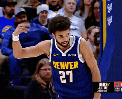 A Man Wearing A Denver Jersey Number 27 Stands In Front Of A Crowd GIF