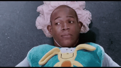 A Man Wearing A Diaper And Holding A Stuffed Bunny GIF