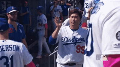 A Man Wearing A Dodgers Jersey Waves To A Fan GIF