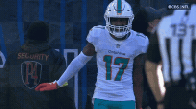 A Man Wearing A Dolphins Jersey With The Number 17 On The Front GIF