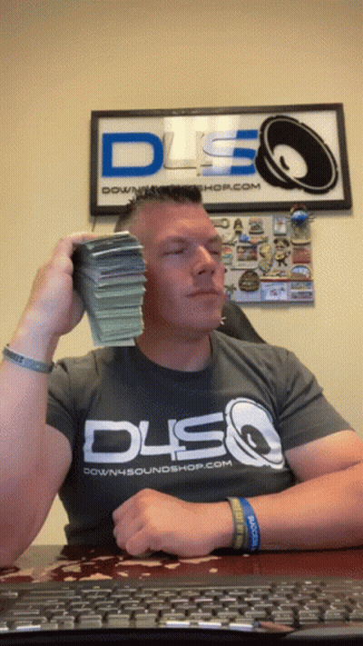 A Man Wearing A Downsoundshop.com Shirt Is Holding A Stack Of Money In Front Of His Face GIF
