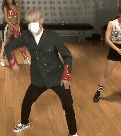 A Man Wearing A Face Mask Is Dancing On A Wood Floor GIF