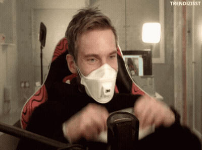 A Man Wearing A Face Mask Is Sitting In A Chair With The Words Trendizisst Above Him GIF
