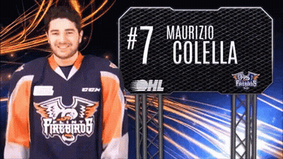 A Man Wearing A Firebirds Jersey Stands In Front Of A Sign That Says # 7 Maurizio Colella GIF